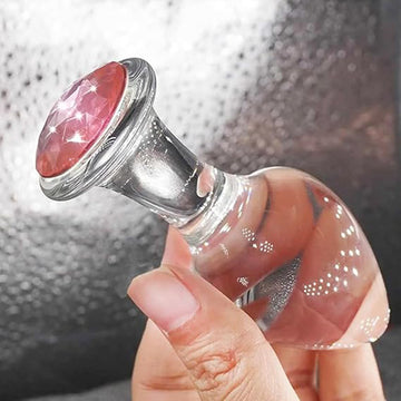 Clear glass anal plug with pink rhinestone tip and wide silver base