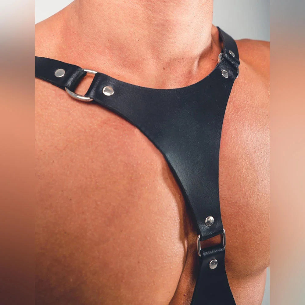 Black faux leather chest harness strap with silver grommets and adjustable buckle