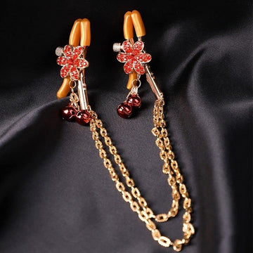 Red flower nipple clamps with layered gold chain and dangling heart bell charms