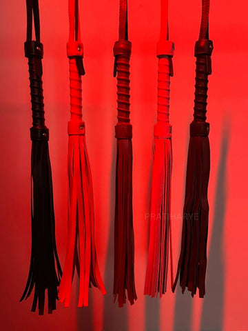 Set of black and red whip floggers with hanging braided tassels